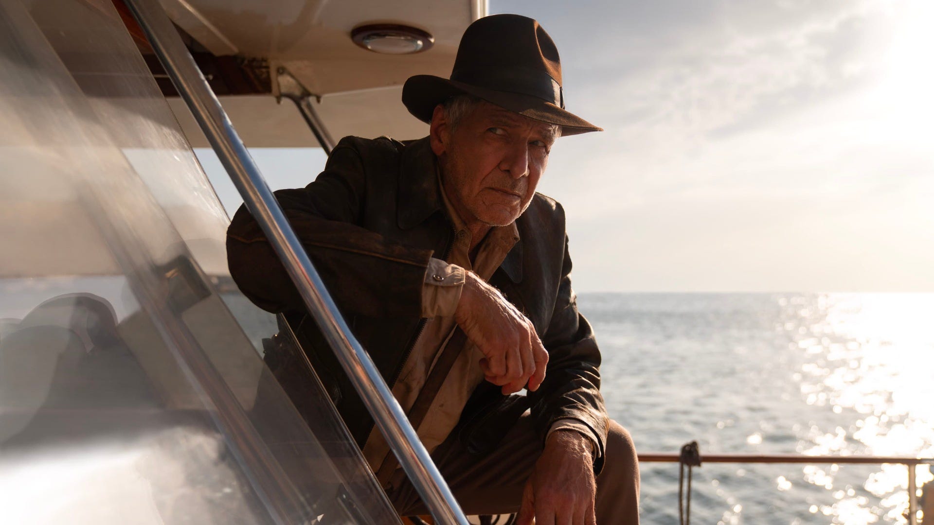 Harrison Ford leaning on the side of a boat