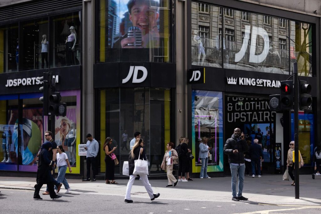 Billionaire’s JD Sports Cuts Profit Forecast Amid ‘Challenging And Volatile Market’