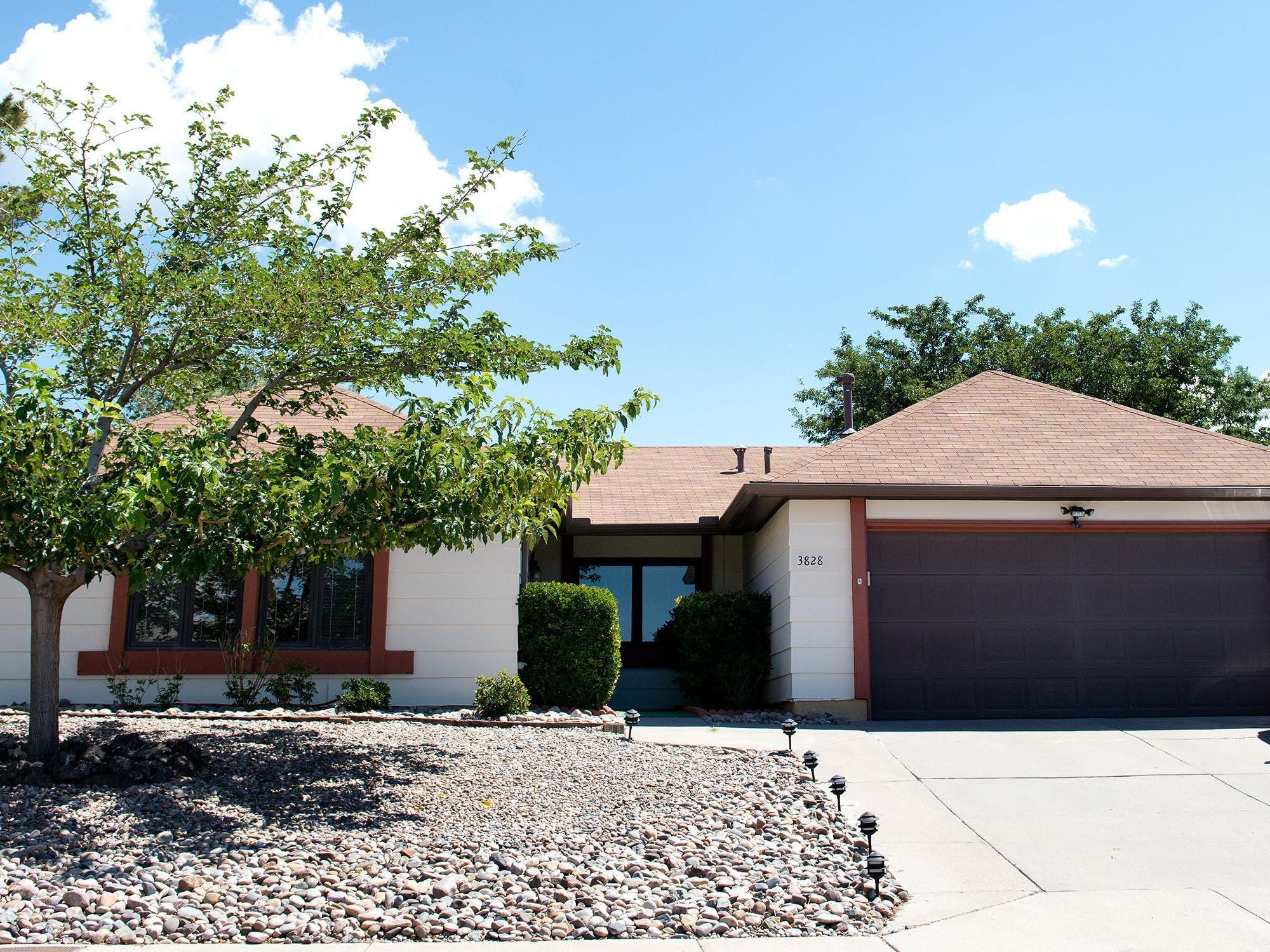 A plain, ranch-style home with white and brown accents.