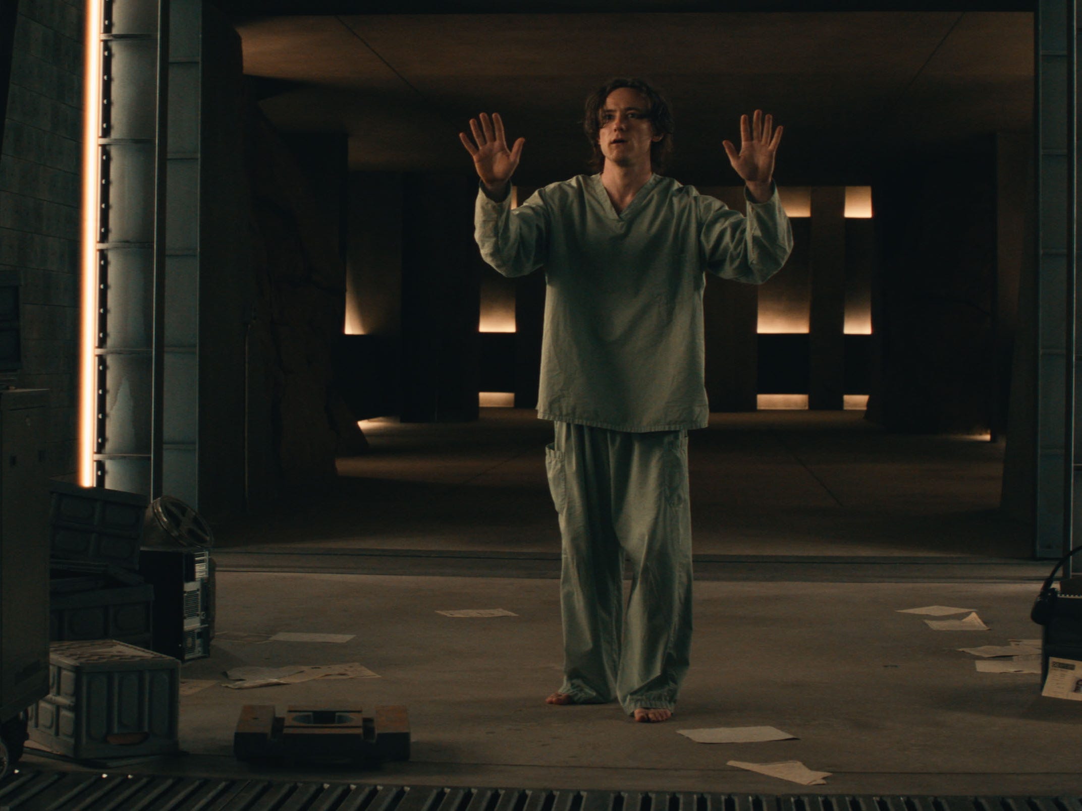 A still of "Thunderbolts*" showing a man in gray outfit with his hands up.