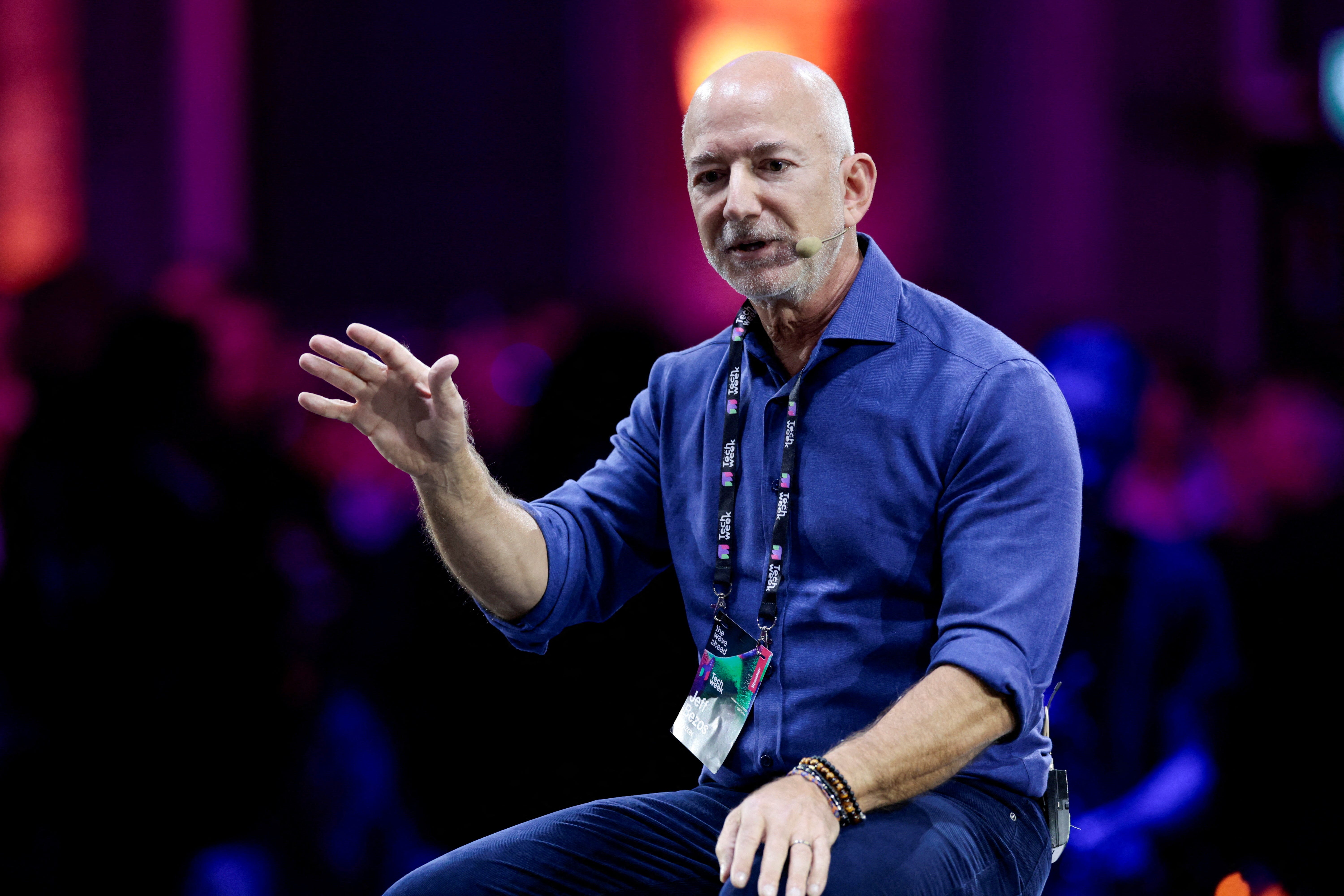 Amazon founder Jeff Bezos gestures as he speaks at the main panel of Italian Tech Week 2025 in Turin, Italy, on October 3, 2025