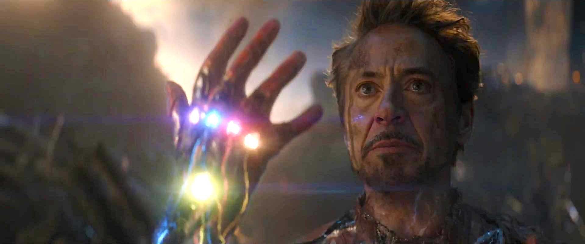 Robert Downey Jr. as Iron Man, holding up a gauntlet with six stones, in "Avengers: Endgame."