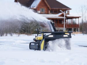 Man Clears Driveway With Autonomous Snow Blower During Storm