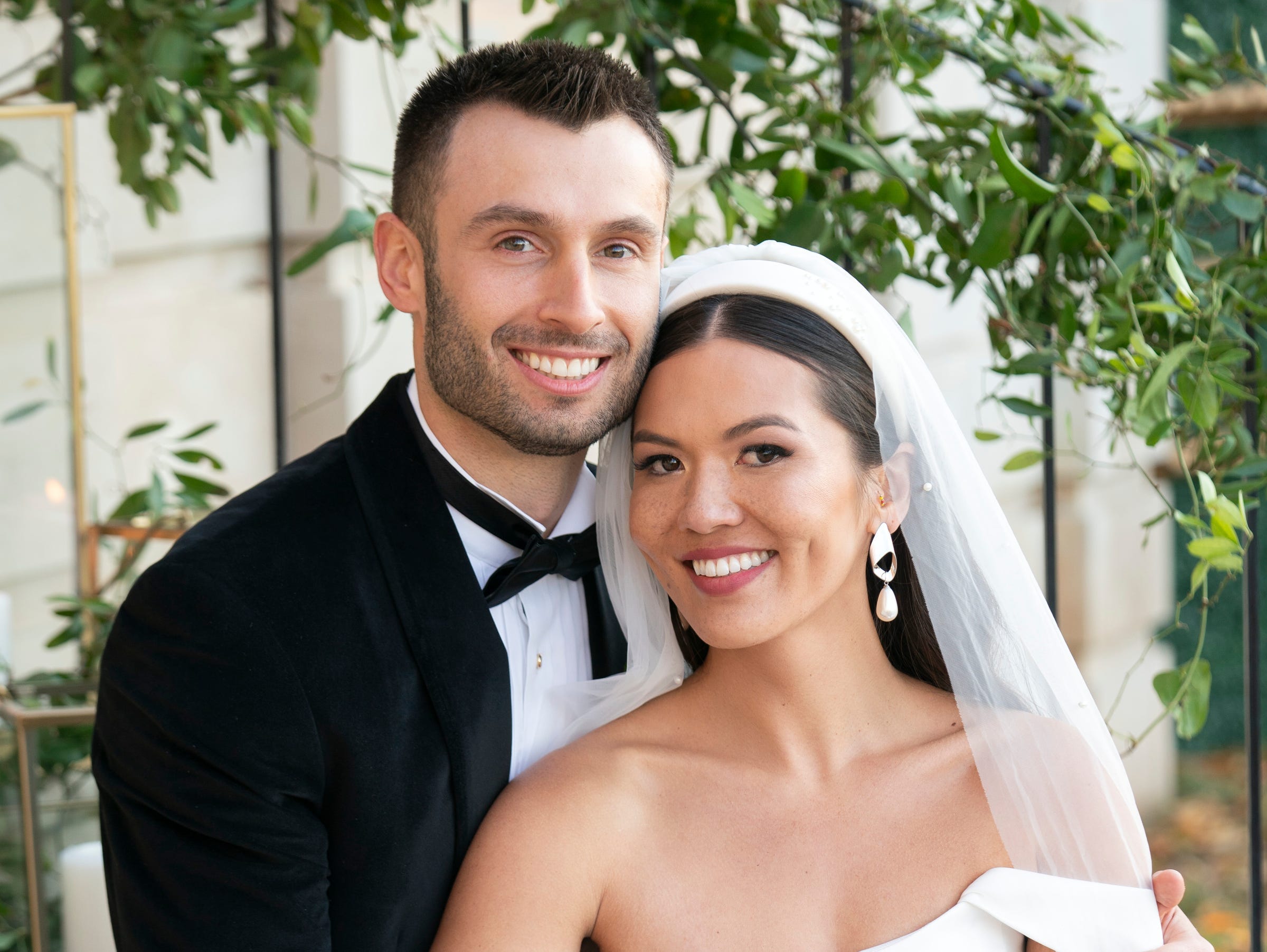 taylor and garrett at their wedding in love is blind season seven, posing together and smiling
