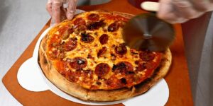 Elon Musk and OpenAI posture over pizza as the AI talent war heats up