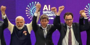 AI’s top leaders got corralled into holding hands. It made for a photo op for the ages.