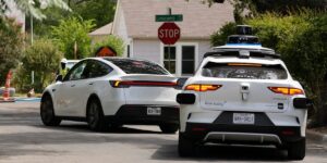 Tesla says its cars should drive themselves as humans do. Waymo says the bar is higher.