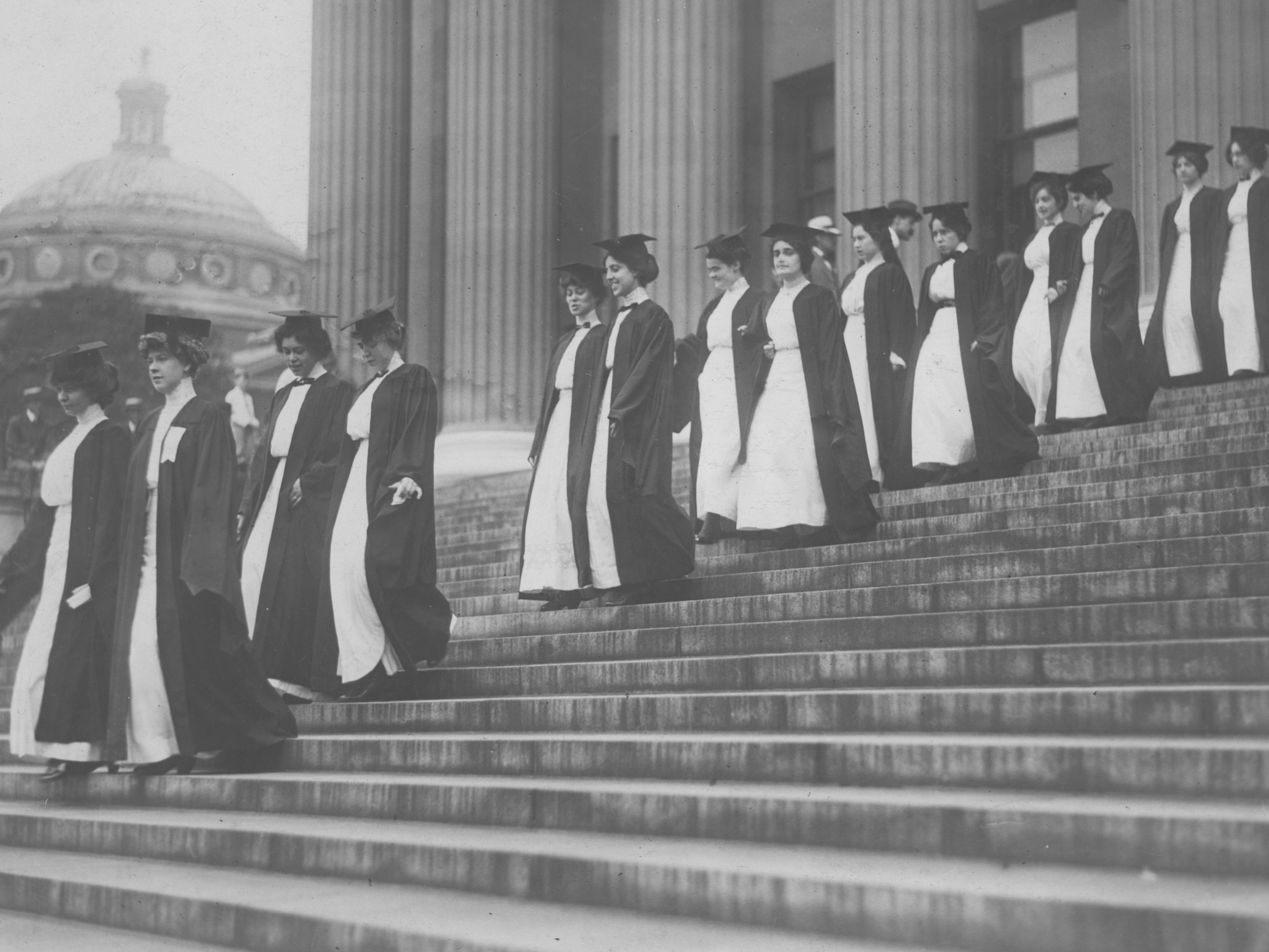Women walk down steps during commencement at Barnard College.