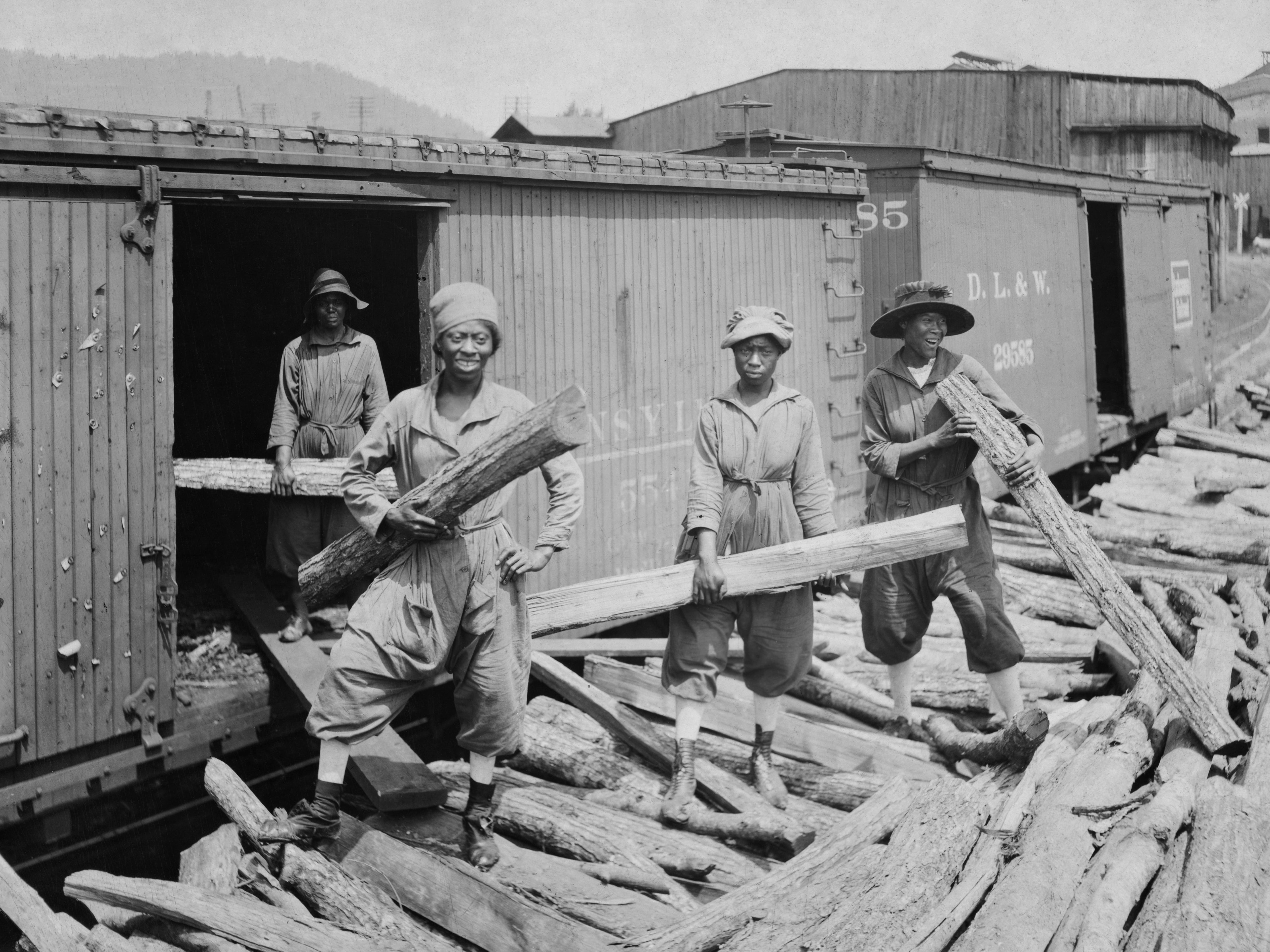 Four Black women holding pieces of lumber at a lumber yard in Louisiana, circa 1925.