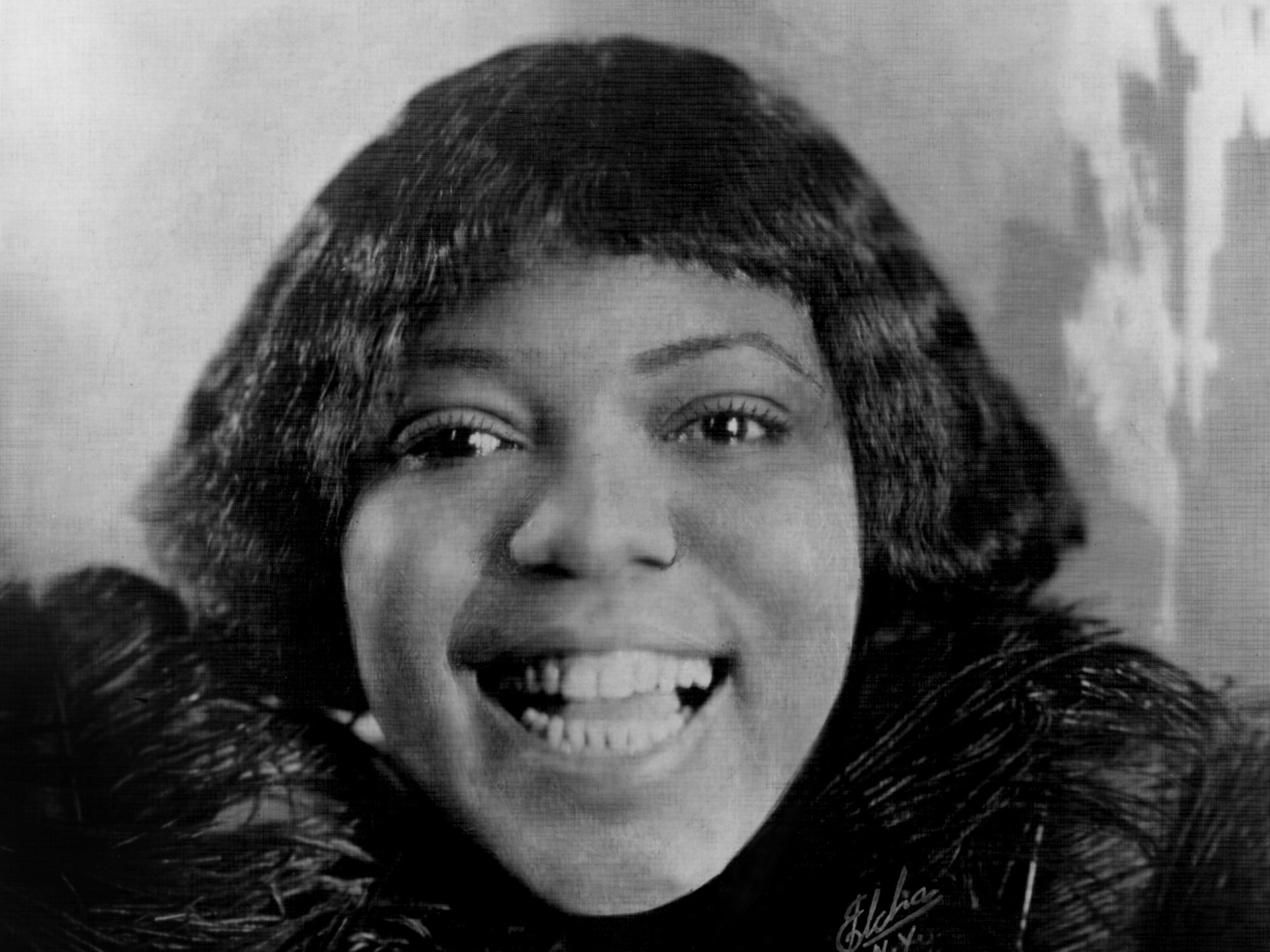 A closeup of Bessie Smith smiling in 1925.