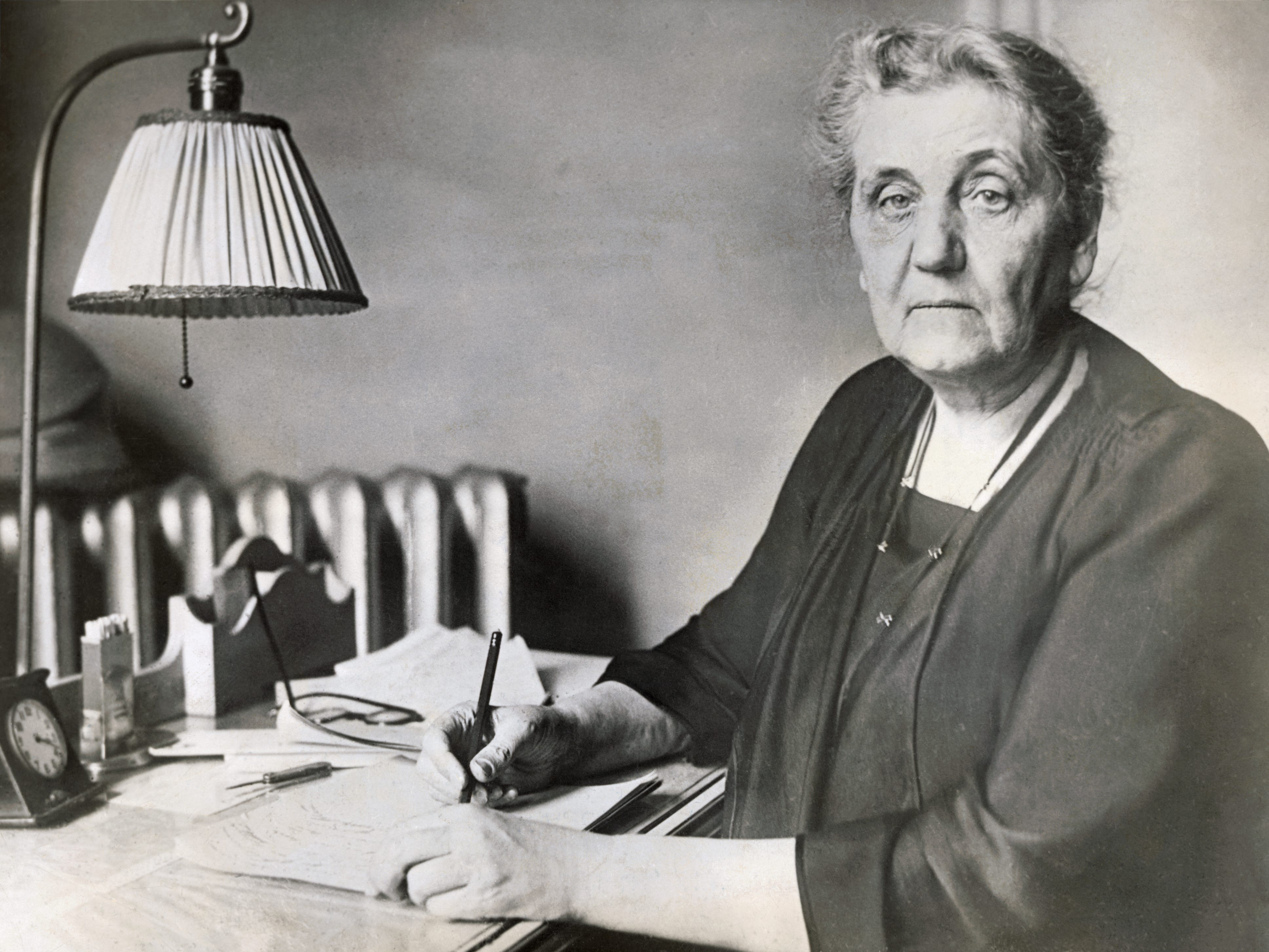 Jane Addams writing at her desk.
