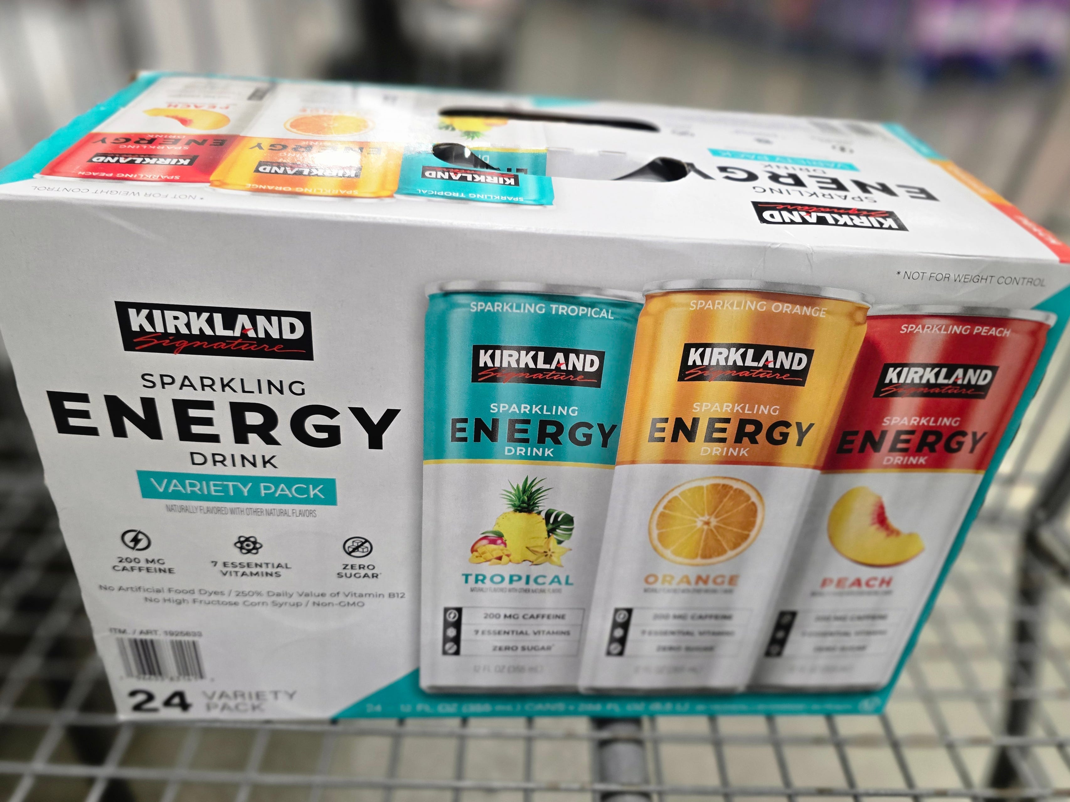 A box of Kirkland Signature sparkling energy drinks in a shopping cart.
