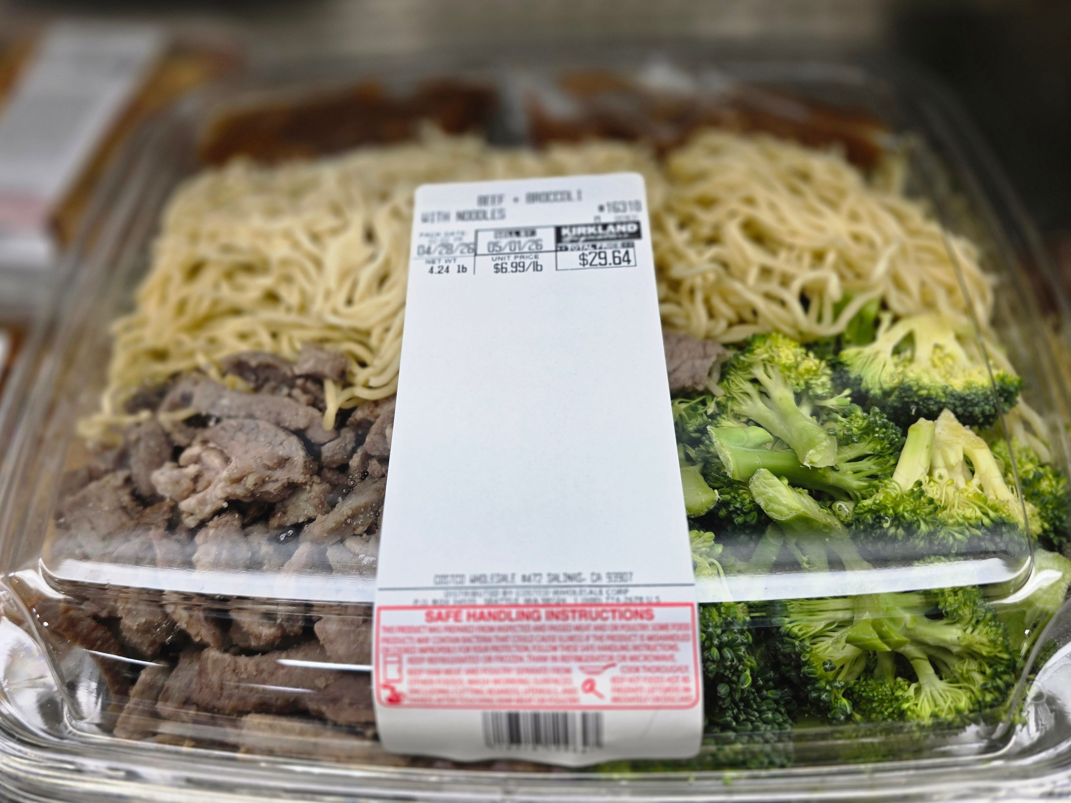 A container of premade Kirkland Signature beef and broccoli.