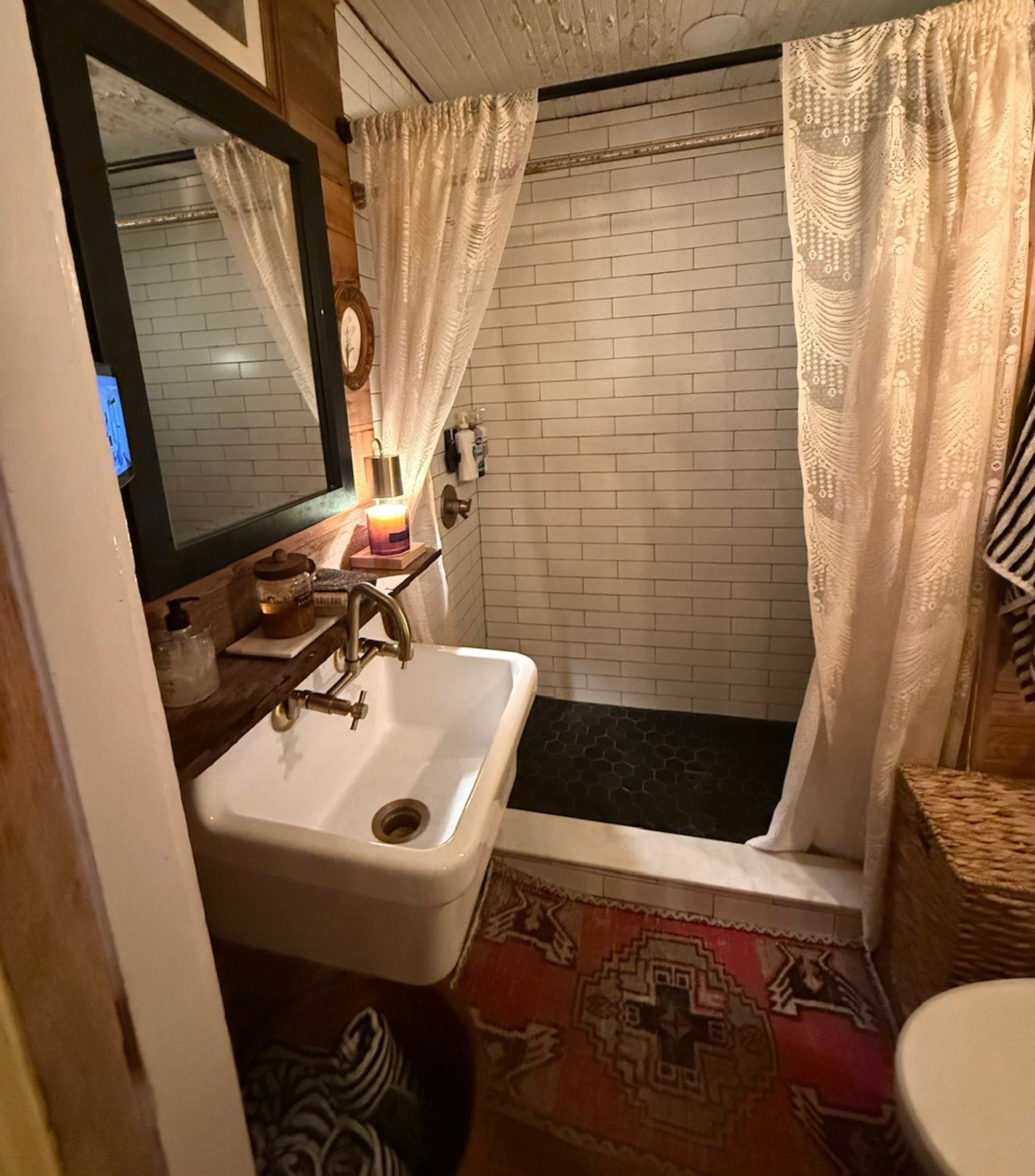 A sall bathroom with a sink, toilet, and shower.