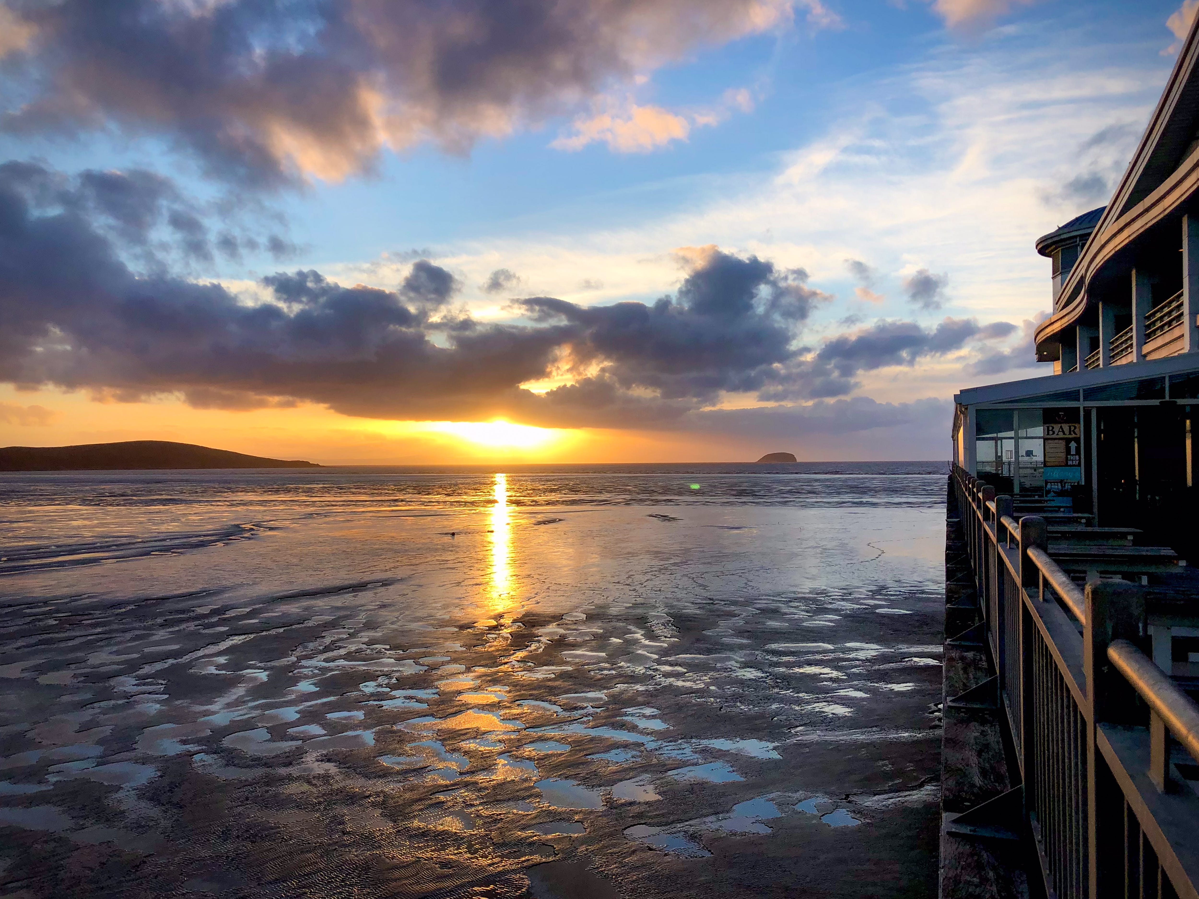 The sun setting on the beach in Weston-super-Mare, England.
