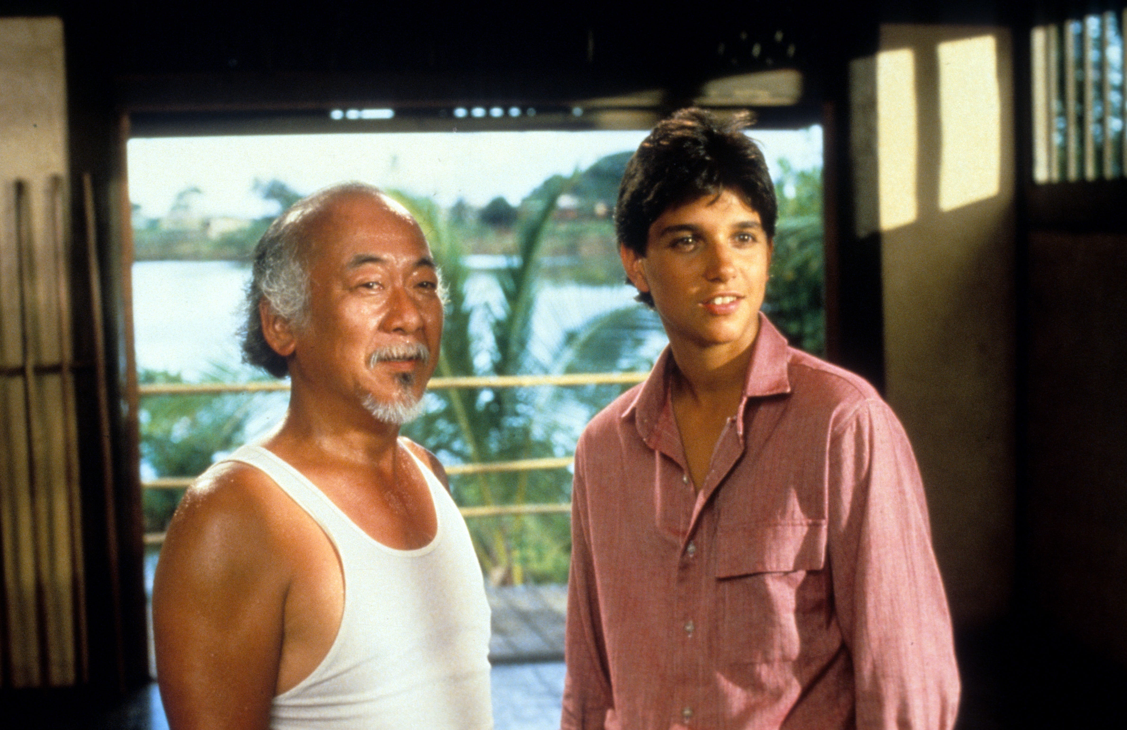 Pat Morita and Ralph Macchio standing next to each other