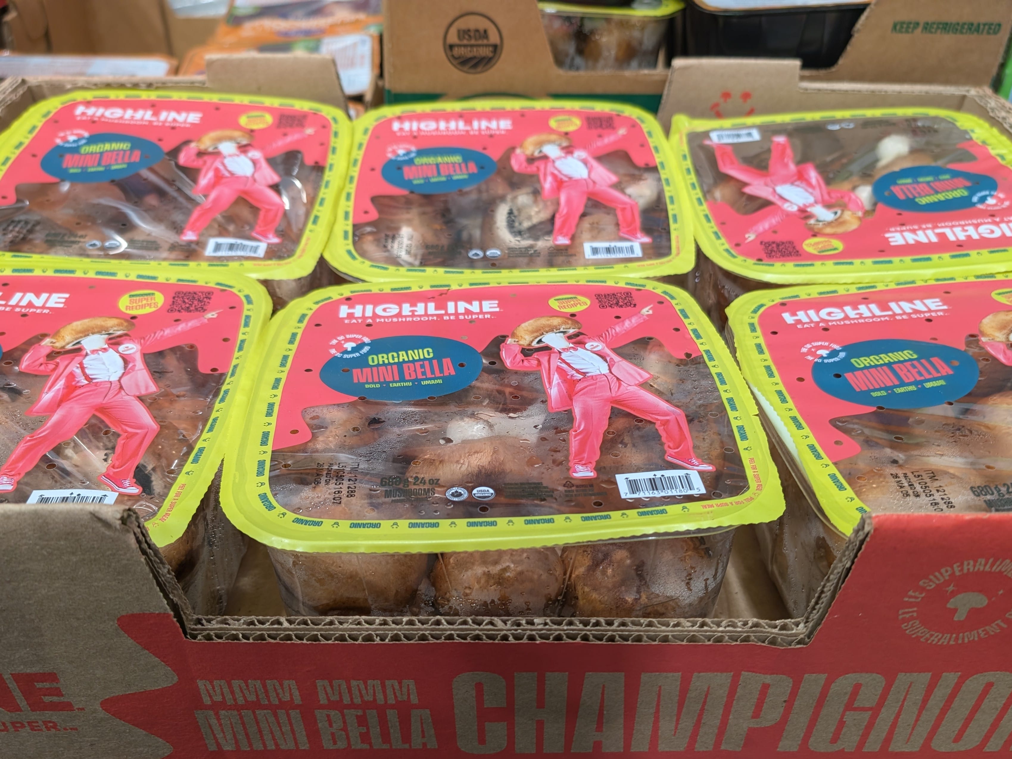 Several containers of Highline organic mini bella mushrooms.