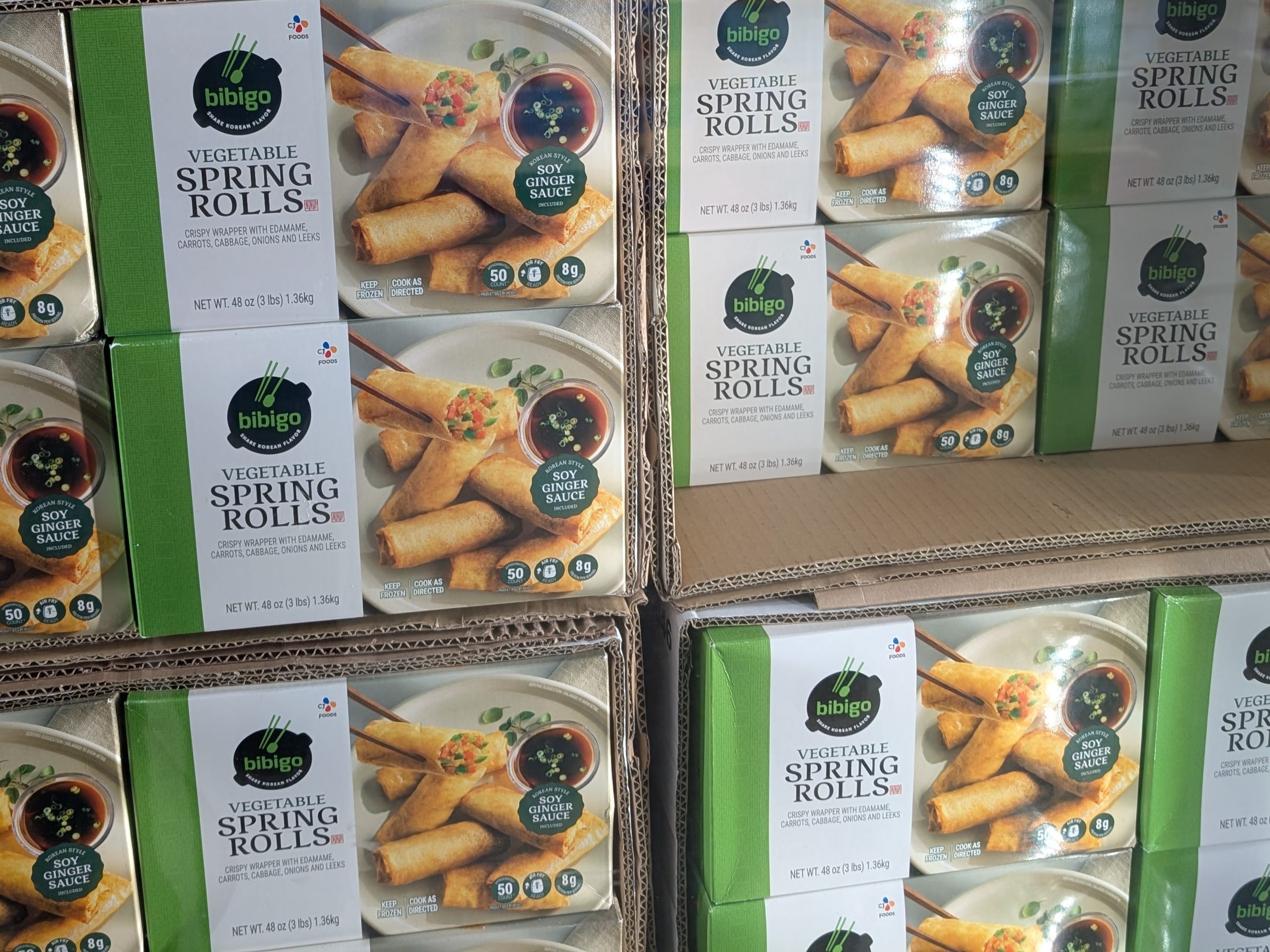 Multiple boxes of Bibigo vegetable spring rolls.