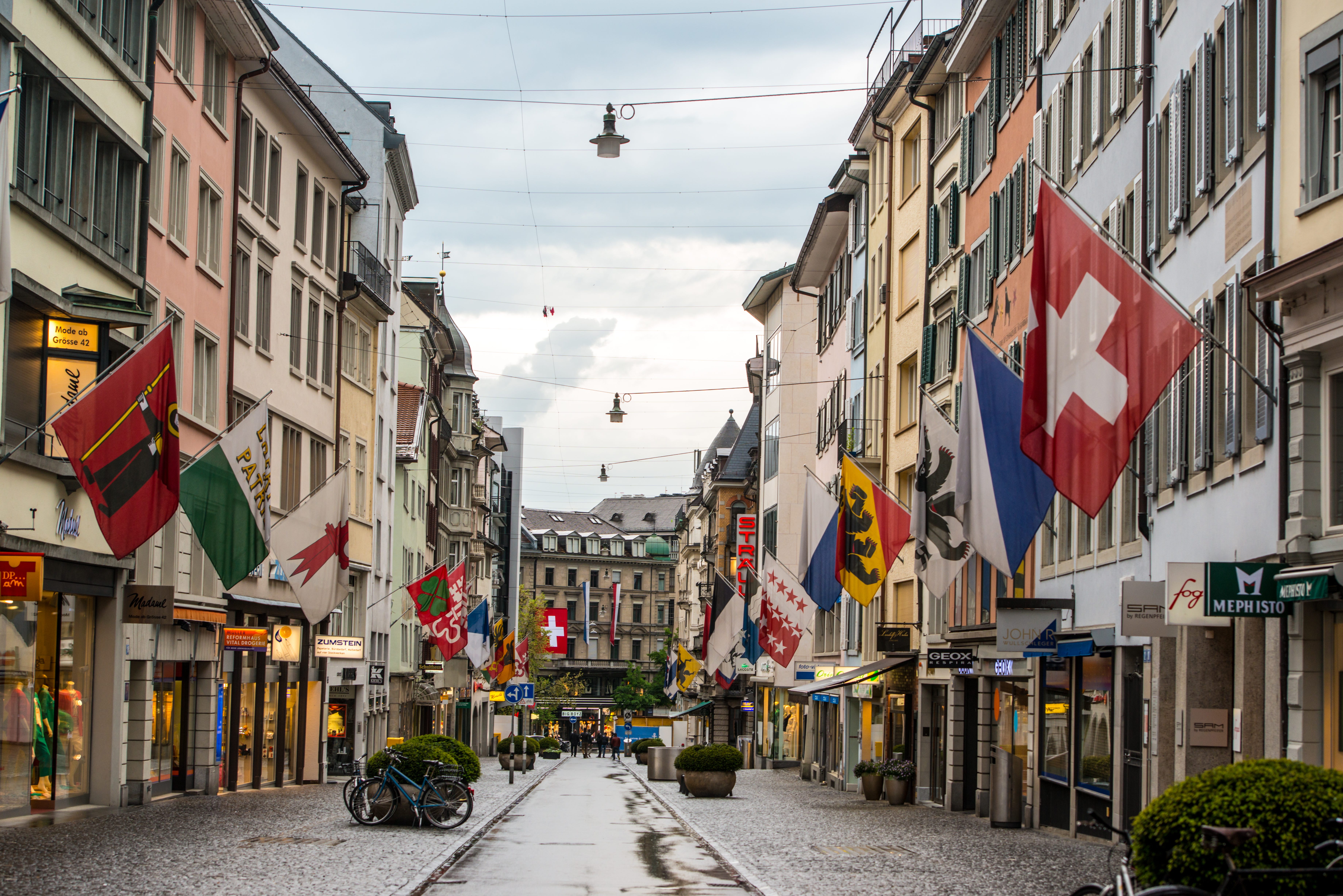 Rainy Zurich street with shops