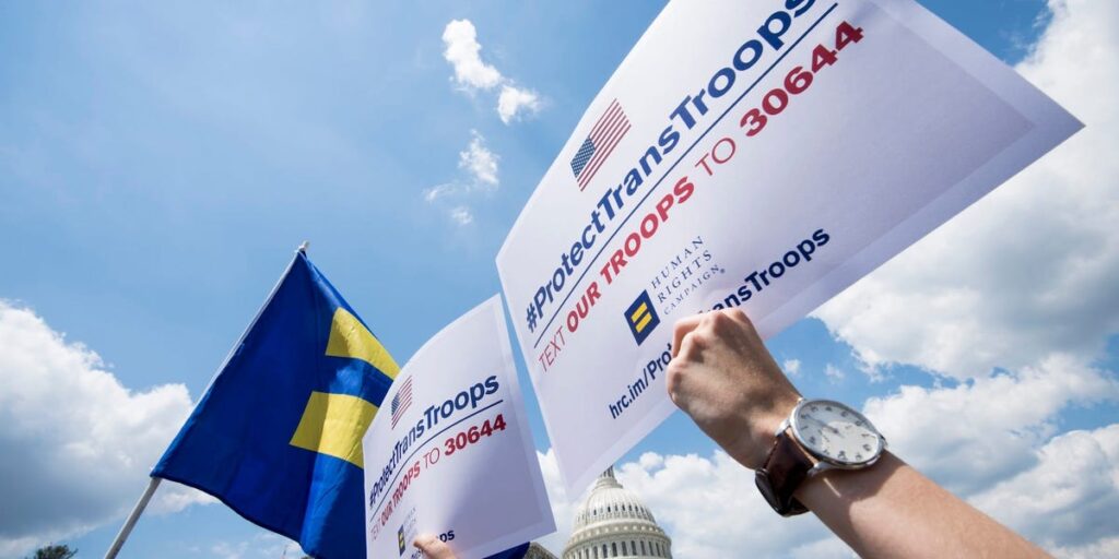 Transgender US troops can continue serving for now, in a major reversal for Trump