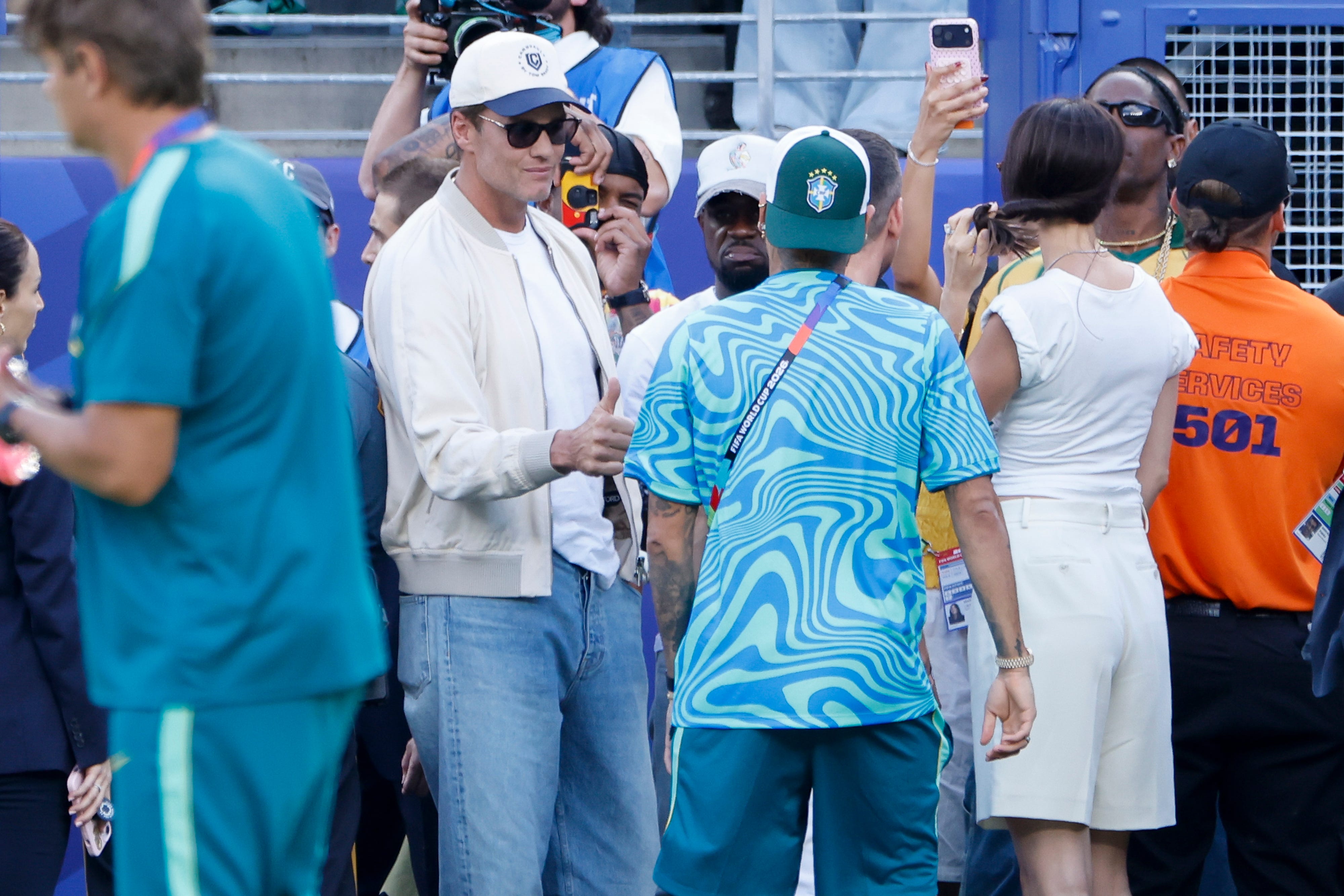 Tom Brady salutes Neymar Jr #10 of Brazil on the pitch before the FIFA World Cup 2026 Group C football match between Brazil and Morocco at New York New Jersey Stadium on June 13, 2026 in East Rutherford, United States.