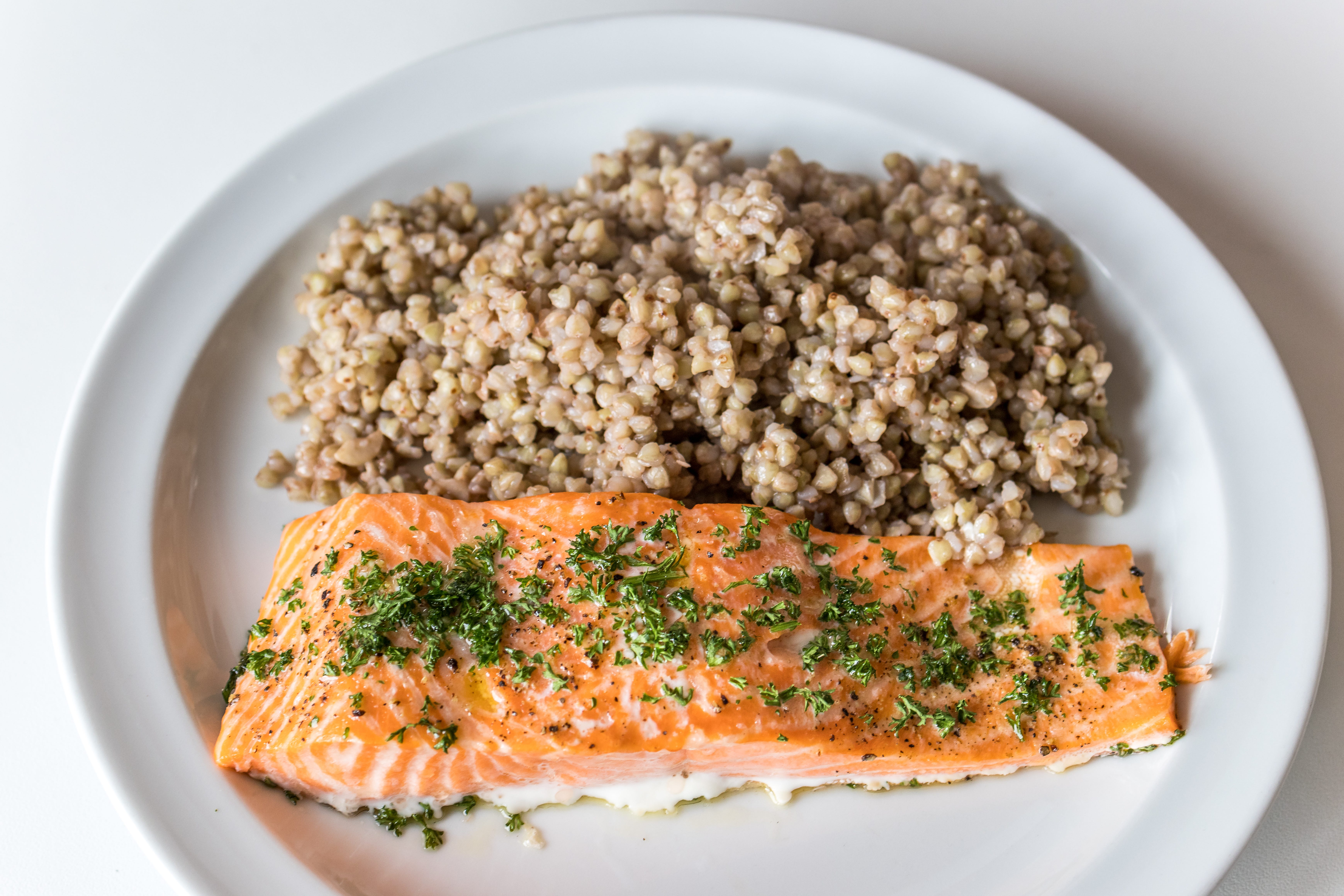 Salmon with herbs on top, grains on the side