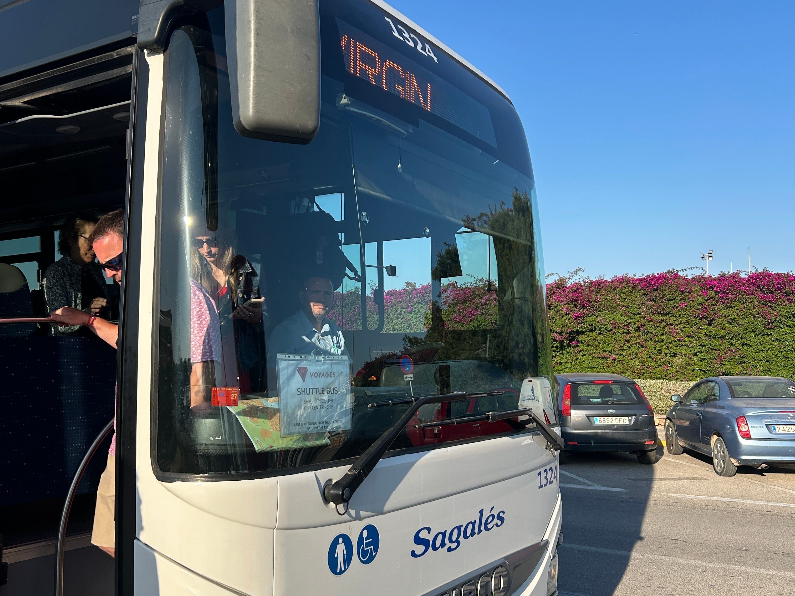 A shuttle bus transporting passengers aboard a Virgin Voyages cruise ship in Ibiza.