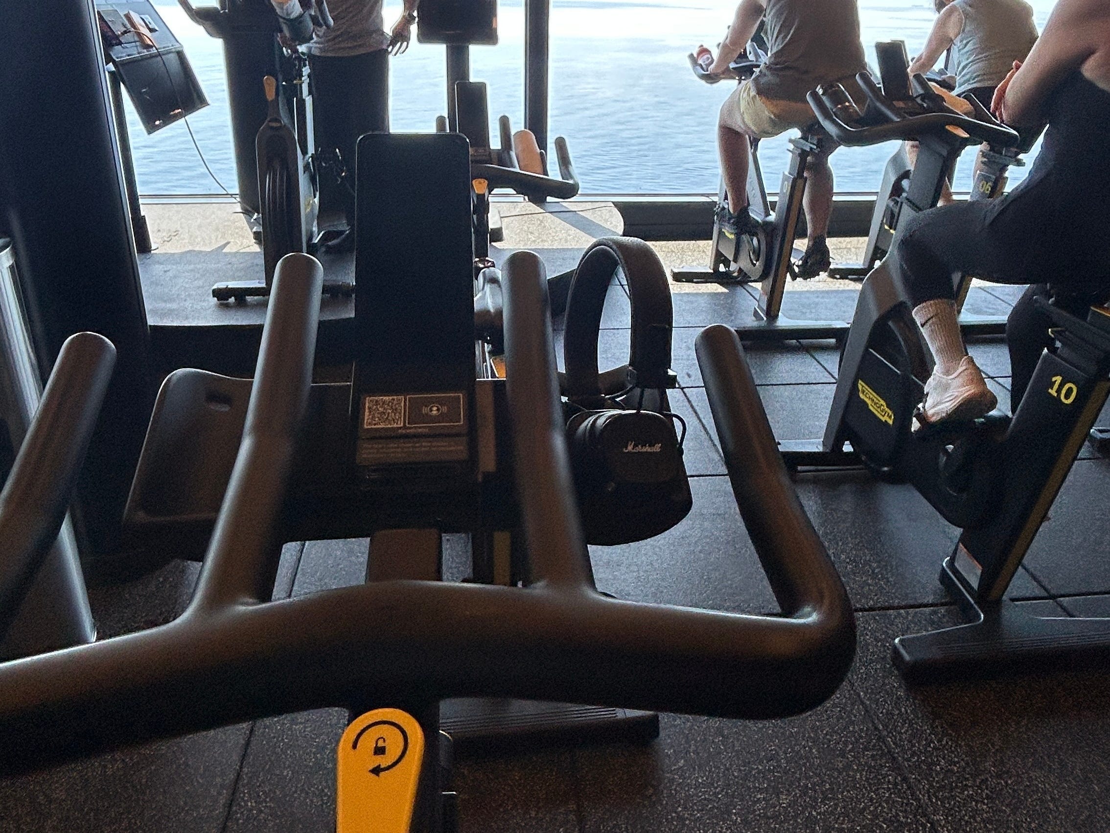 The writer's point of view on a spin bike at a workout class aboard a Virgin Voyages cruise ship.