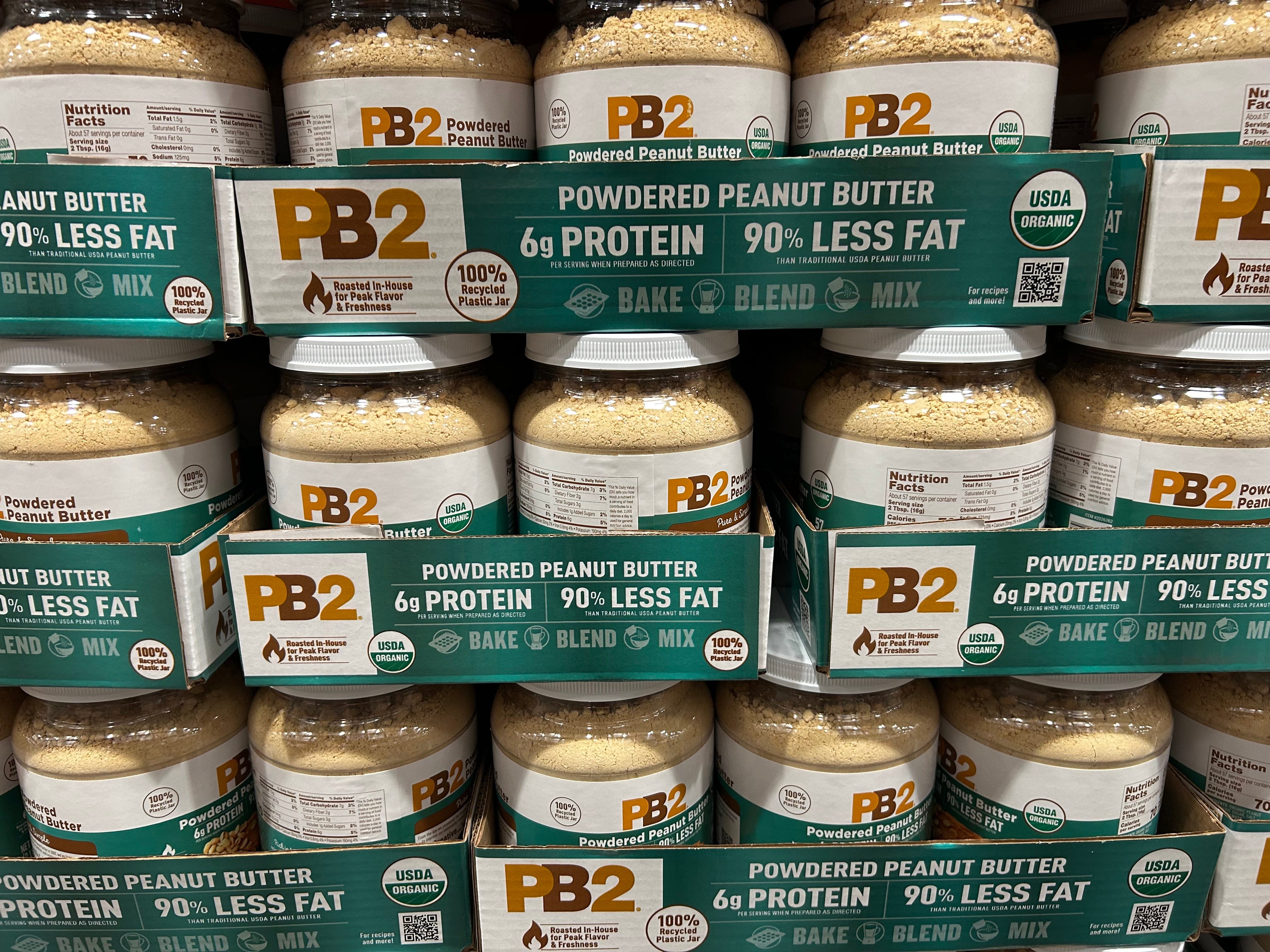 Containers of PB2 powdered peanut butter on display at Costco.
