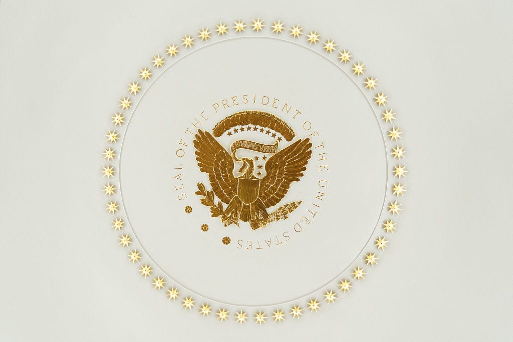 The seal of the president covered in gold in the Oval Office.