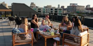Third places are out, as prices rise. Hosting dinners, craft nights, and book clubs are in.