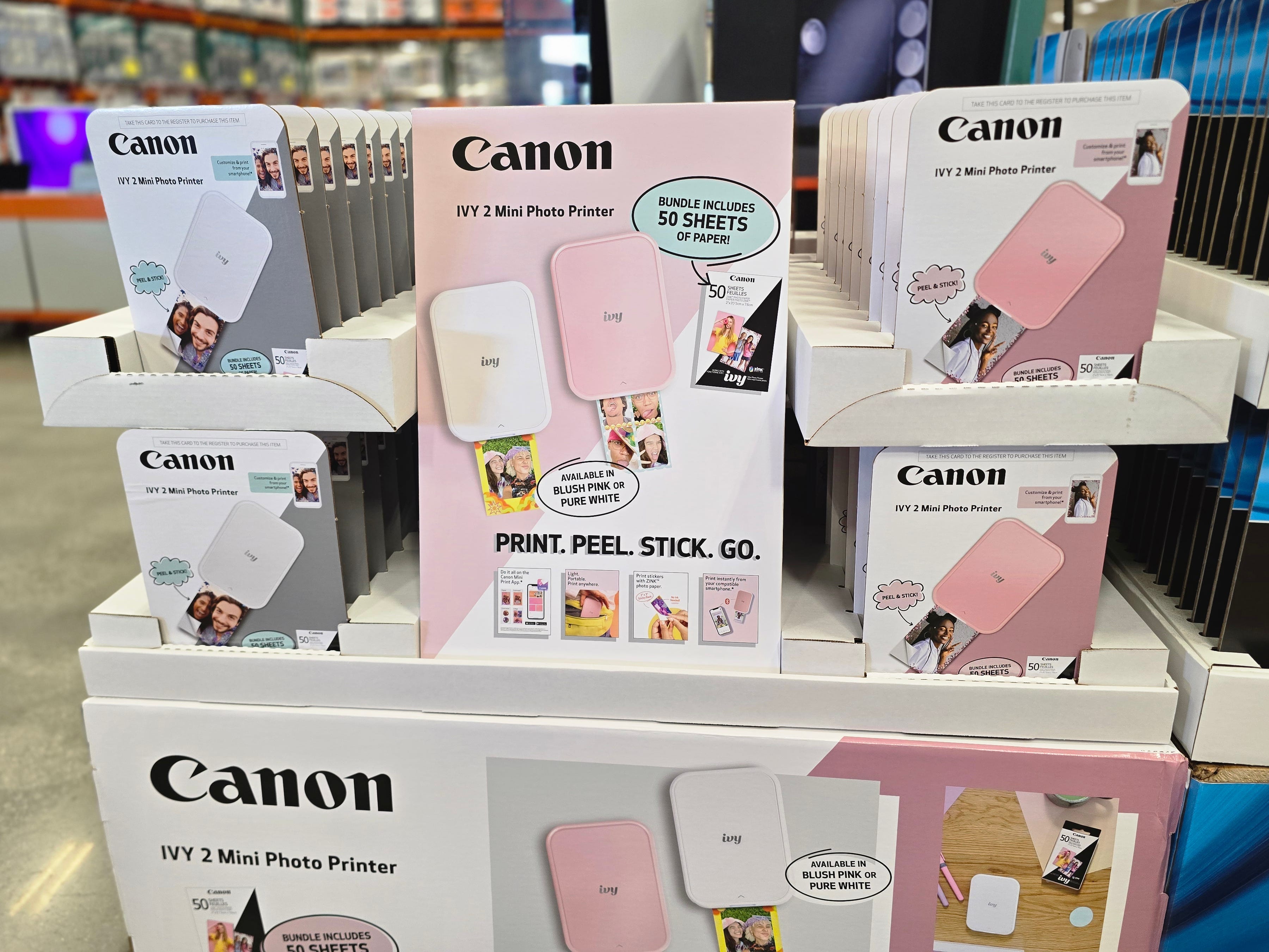Boxes of Canon Ivy 2 mini photo printers on display at Costco.