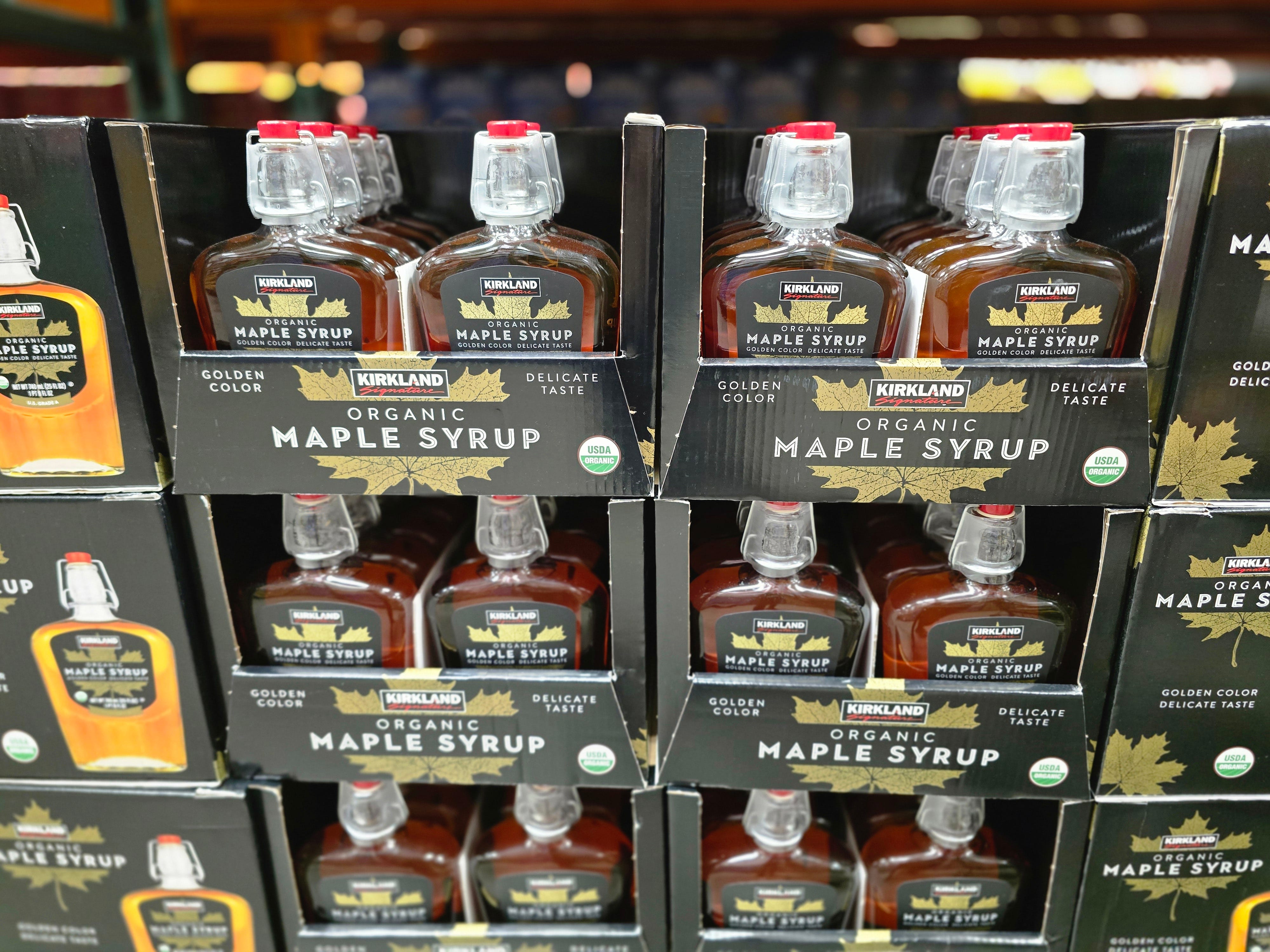 Bottles of Kirkland Signature organic maple syrup on display at Costco.